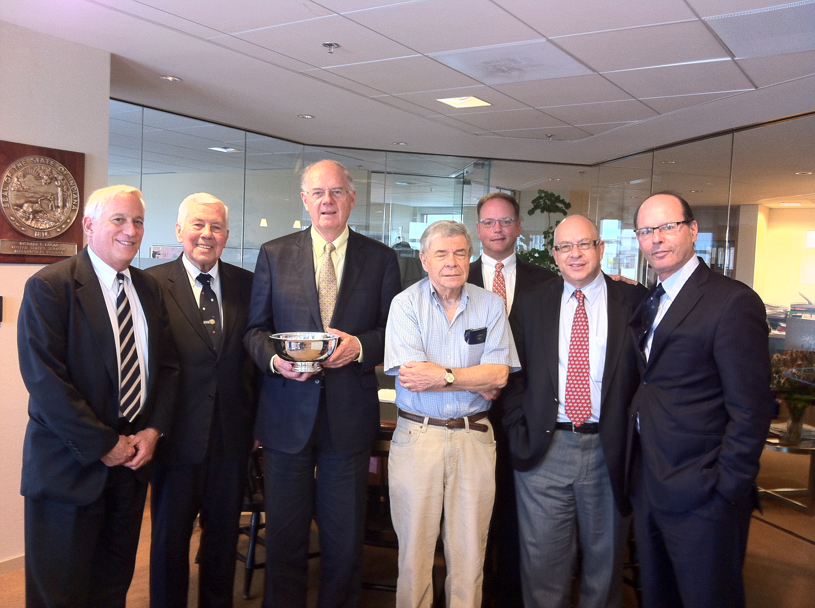 L to R: Walter Isaacson ’74, Dick Lugar ’54, Giles Henderson (with Revere bowl), Revan Tranter ’54, Bradley Peacock ’92, Andrew Seton, Tom Herman ’71 (missing: Neil Arnold ’66, Jim Bratton ’52, and Michelle Peluso ’93)