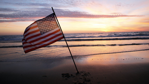 An American flag is placed in the sand of Omaha Beach, western France. The 75th anniversary of the D-Day invasion by U.S., British and Canadian troops is June 6, 2019. (Photo by Thibault Camus, Associated Press)